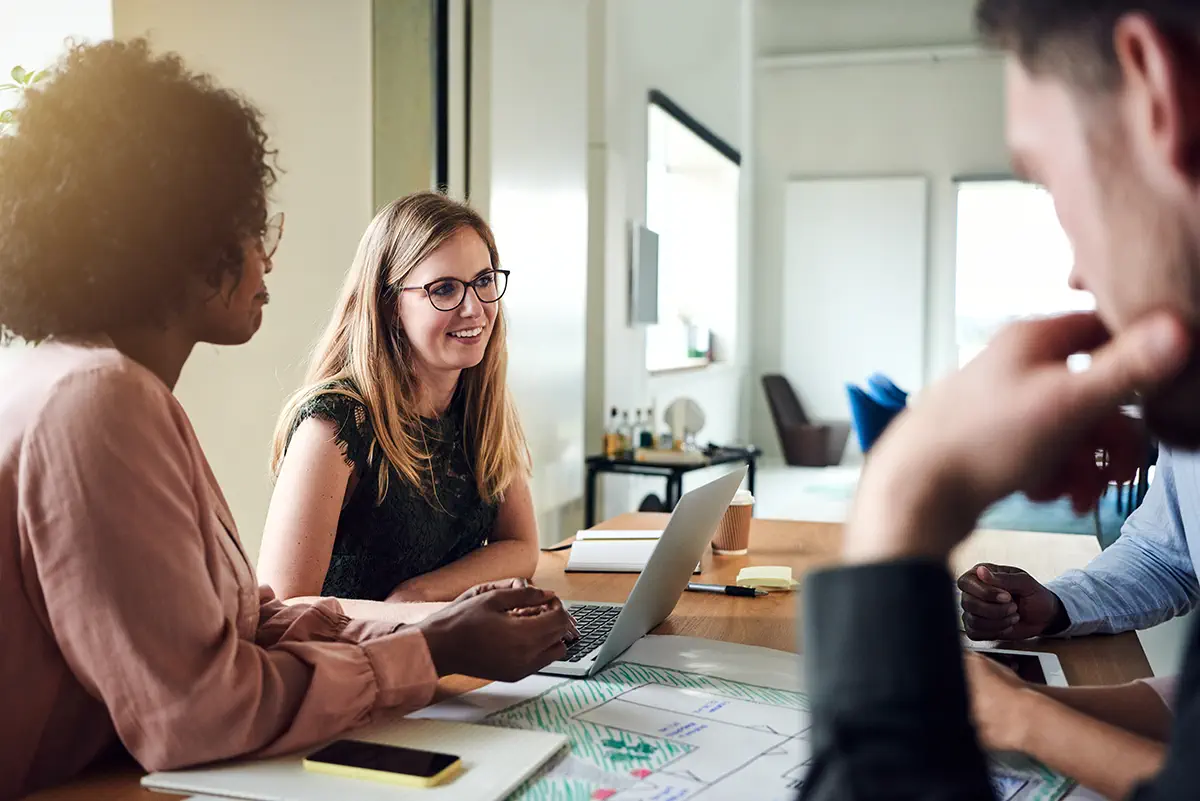 four workers talking in a meeting